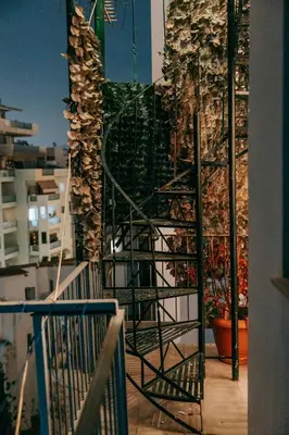 a stairway leading up to a balcony with a stone wall at Acropoli's balcony in Athens