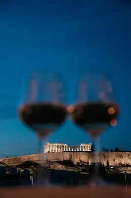 two glasses of wine in front of the acropolis at Acropoli's balcony in Athens