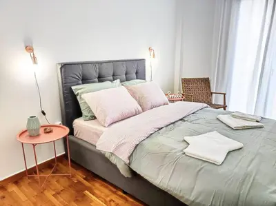 a bedroom with a large bed with a side table at As ✓Two bedroom apartment in thissio in Athens