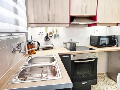 a small kitchen with a sink and a stove at As ✓Two bedroom apartment in thissio in Athens