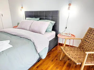 a bedroom with a bed and a chair and a table at As ✓Two bedroom apartment in thissio in Athens