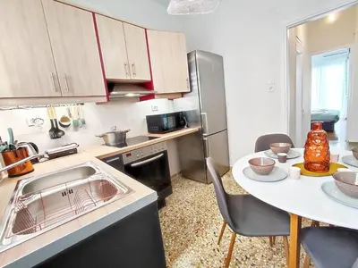 a kitchen with a sink and a table with chairs at As ✓Two bedroom apartment in thissio in Athens