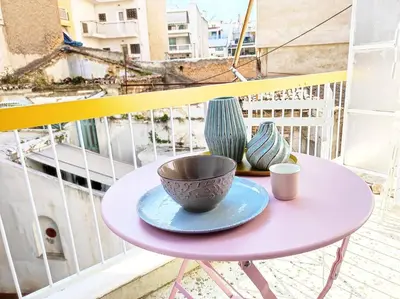 a pink table with a bowl and vases on a balcony at As ✓Two bedroom apartment in thissio in Athens