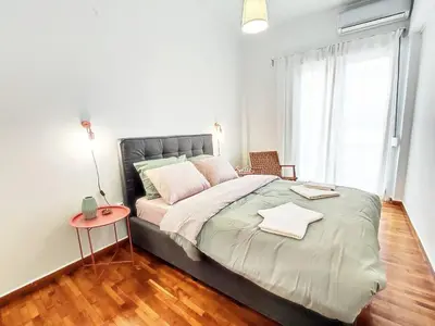 a bedroom with a large bed and a table at As ✓Two bedroom apartment in thissio in Athens