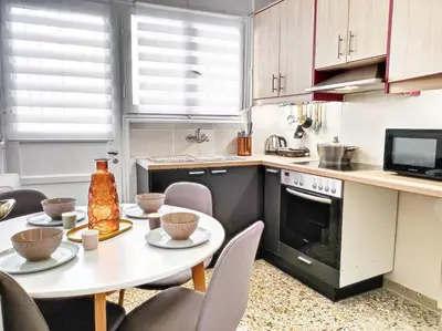 a kitchen with a table with chairs and an oven at As ✓Two bedroom apartment in thissio in Athens