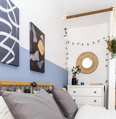 a bedroom with a bed and a mirror at Boho Blu by A&D Properties in Porto Rafti