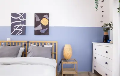 a bedroom with blue and white walls at Boho Blu by A&D Properties in Porto Rafti