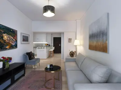 a living room with a couch and a table at Newly Renovated Apartment in the Heart of Athens in Athens