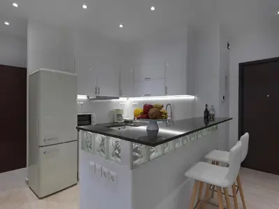 a kitchen with a bowl of fruit on a counter at Newly Renovated Apartment in the Heart of Athens in Athens