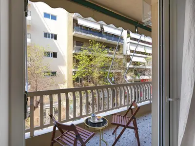 a balcony with two chairs and a table at Newly Renovated Apartment in the Heart of Athens in Athens