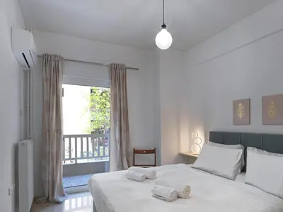 a bedroom with a bed with two towels on it at Newly Renovated Apartment in the Heart of Athens in Athens