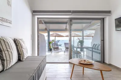 a living room with a couch and a table at Pallas Seaside 1 in Athens