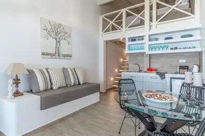a living room with a couch and a table at Pallas Seaside 2 in Athens