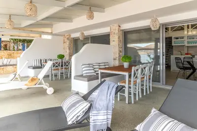 a patio with chairs and a table and a table at Pallas Seaside 2 in Athens
