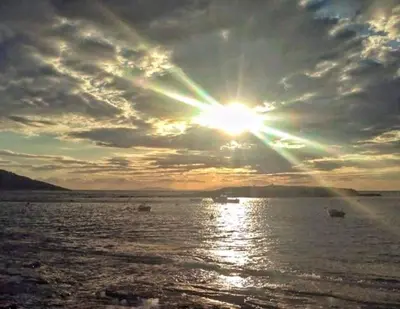 a sun setting over a body of water with boats at Pallas Seaside 2 in Athens
