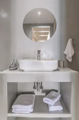 a white bathroom with a sink and a mirror at Pallas Seaside 2 in Athens