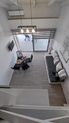 a living room with a couch and a table at Pallas Seaside 2 in Athens