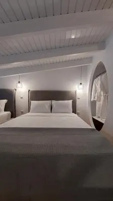 a bedroom with a large bed and a round window at Pallas Seaside 2 in Athens