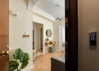 an open door to a hallway with a room with a table at HoneyBee Apartment in Athens
