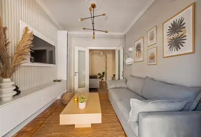 a living room with a couch and a table at HoneyBee Apartment in Athens