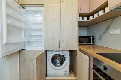 a laundry room with a washer and dryer in a kitchen at HoneyBee Apartment in Athens