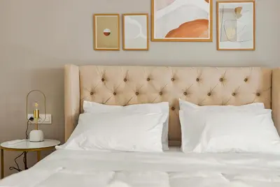 a bedroom with a bed with white pillows at HoneyBee Apartment in Athens