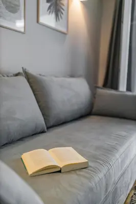 a book sitting on top of a couch at HoneyBee Apartment in Athens