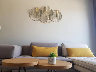 a living room with a couch and two tables at Elegant House With Acropolis View in Athens