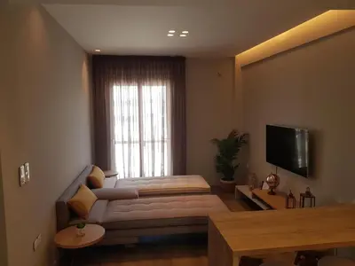 a living room with a couch and a television at Elegant House With Acropolis View in Athens