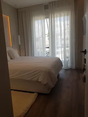 a bedroom with a large bed and a large window at Elegant House With Acropolis View in Athens