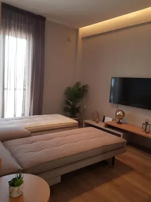 a bedroom with a large bed and a flat screen tv at Elegant House With Acropolis View in Athens