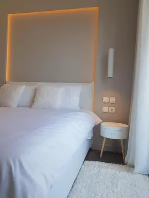 a bedroom with a white bed and a table at Elegant House With Acropolis View in Athens