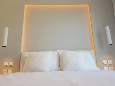 a bedroom with a white bed with white pillows at Elegant House With Acropolis View in Athens