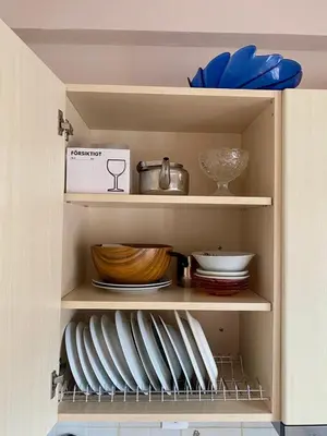 a cabinet filled with plates and bowls and dishes at Charming flat with an amazing view in Athens