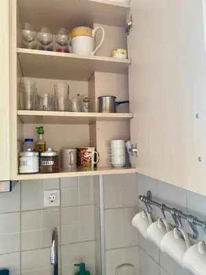 a kitchen with shelves filled with pots and pans at Charming flat with an amazing view in Athens