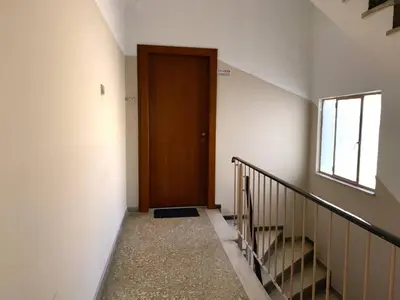 a hallway with a wooden door and a staircase at Charming flat with an amazing view in Athens