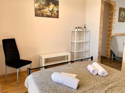 a bedroom with a bed and a chair and a table at Charming flat with an amazing view in Athens