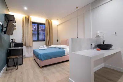 a bedroom with a bed and a sink in it at Dunlin Hotel in Athens
