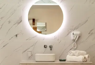 a bathroom with a sink and a mirror at Dunlin Hotel in Athens