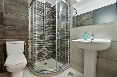 a bathroom with a shower and a toilet and a sink at Beautiful new apartment 5 min from Piraeus Port (A2) in Piraeus