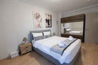 a bedroom with a large bed with towels on it at Waylink Residences - Piraeus Port SPT in Piraeus
