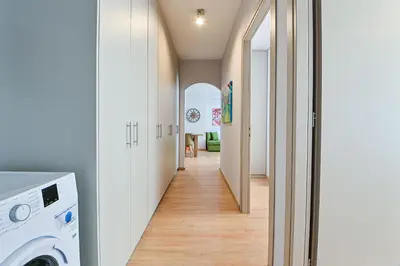 a hallway with a washer and dryer in a house at Waylink Residences - Piraeus Port SPT in Piraeus