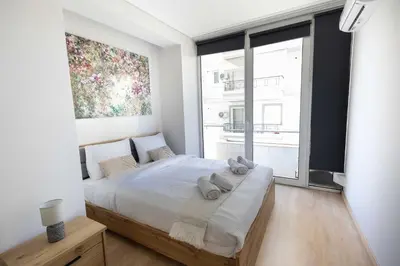 a bedroom with a large bed with a large window at Waylink Residences - Piraeus Port SPT in Piraeus