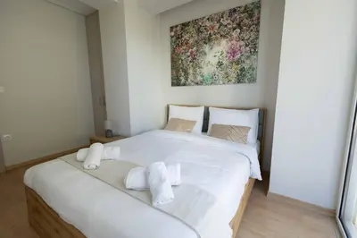 a bedroom with a white bed with towels on it at Waylink Residences - Piraeus Port SPT in Piraeus