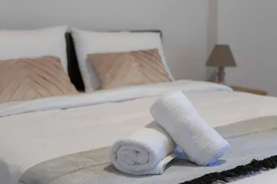 a rolled up towel on a bed in a bedroom at Waylink Residences - Piraeus Port SPT in Piraeus