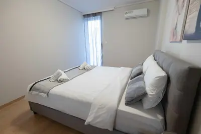 a bedroom with a bed and a couch at Waylink Residences - Piraeus Port SPT in Piraeus