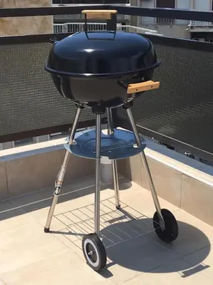 a blue barbecue grill sitting in front of a wall at Cozy Loft with Jazz Notes in Kolonaki in Athens