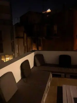 a room with a couch and two chairs and a table at Cozy Loft with Jazz Notes in Kolonaki in Athens