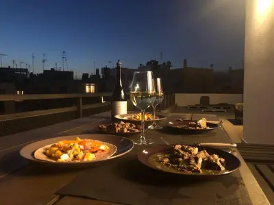 a table with plates of food and a glass of wine at Cozy Loft with Jazz Notes in Kolonaki in Athens