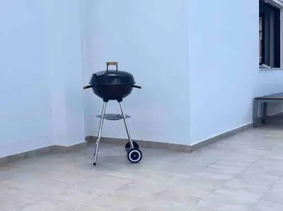 a grill sitting on a stand in a room at Cozy Loft with Jazz Notes in Kolonaki in Athens